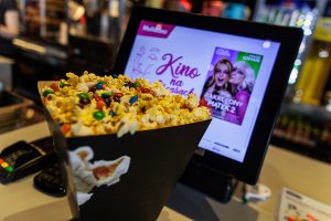 popcorn w kinie na tle tableta przy kasach